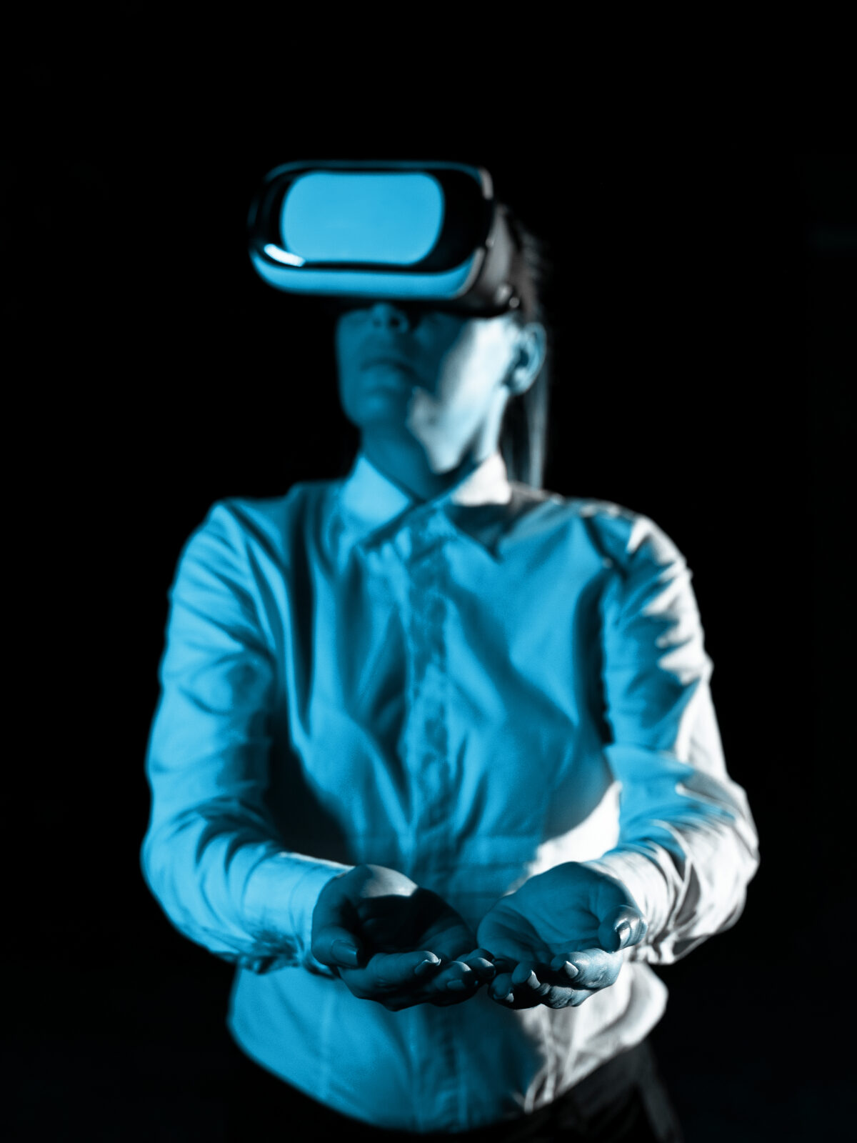 Woman Wearing Vr Glasses And hord Important Messages With two hands. Businesswoman Having Virtual Reality Eyeglasses And Showing Crutial Informations.